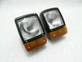 Pair of front headlights with amber indicator lenses, rectangular H4 lamps