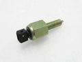 Foot brake switch with green hex body, threaded stud, and black electrical plug